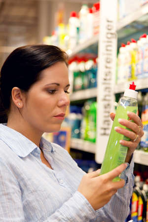 Young woman with shopping cart in the supermarket when shoppingの写真素材