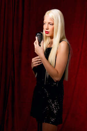 Young blonde girl with an appearance as a singerの写真素材