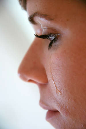 Woman with tears in her faceの写真素材