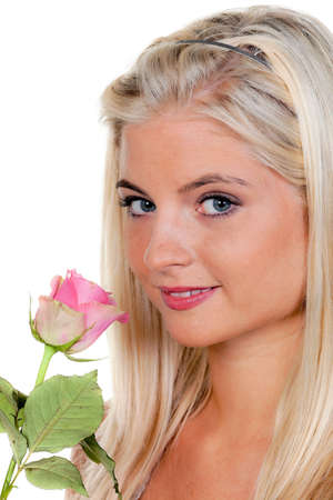 Close-up portrait of a young woman with a pink rose. Vertical.の写真素材