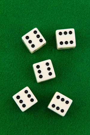 Group of dice with sixes showing, on green felt. Vertical.の写真素材
