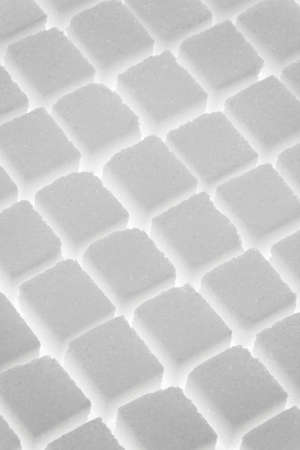 Rows of sugar cubes on white background. Vertical.の写真素材