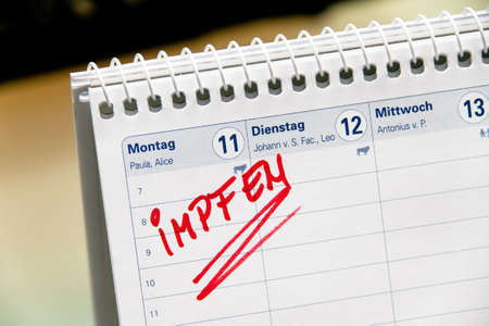 Close-up of German calendar with vaccination reminder. Horizontally framed shot.の写真素材