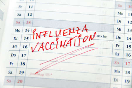Close-up of calendar with vaccination reminder. Horizontally framed shot.の写真素材
