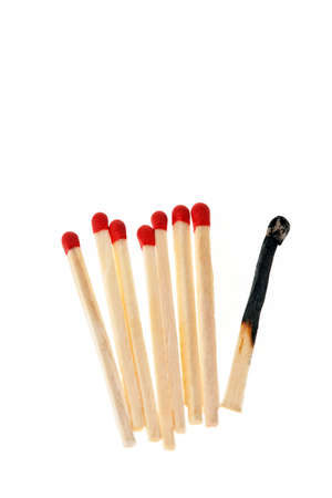 Row of matches with one burnt matchstick. Vertically framed shot.の写真素材