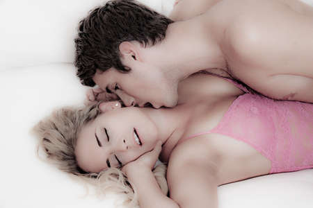 Couple in bed with sex and affection. Love and sex in the bedroom.の写真素材