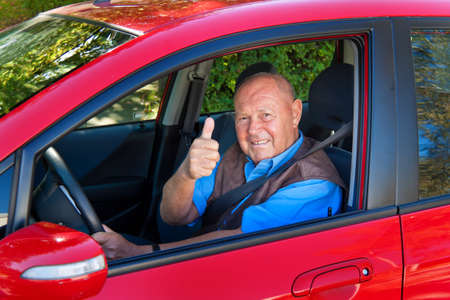 Elderly man wearing a seatbelt when in a car.