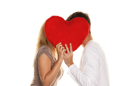 Loving couple kissing behind a heart. Love is beautiful. Secret loveの写真素材