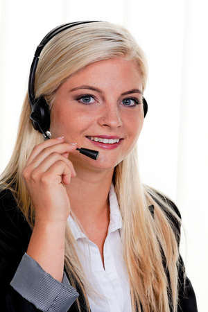 Young woman with telephone headset in a call centerの写真素材