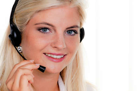 Young woman with telephone headset in a call centerの写真素材