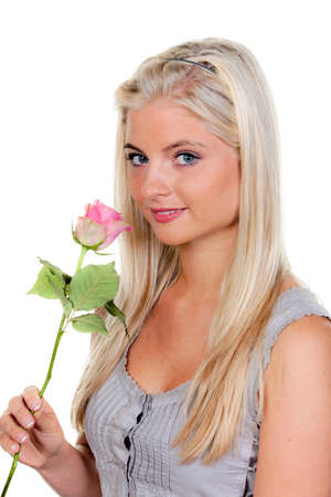 Young Woman with a rose in which they smell.の写真素材