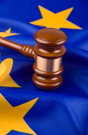 A gavel in court. With a European flag in the background.の写真素材