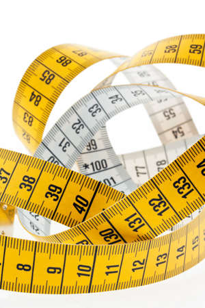 A yellow measuring tape isolated on white background.の写真素材