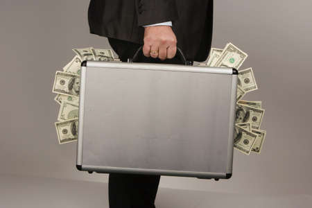 Business man with many dollar bills. Crime in the economyの写真素材