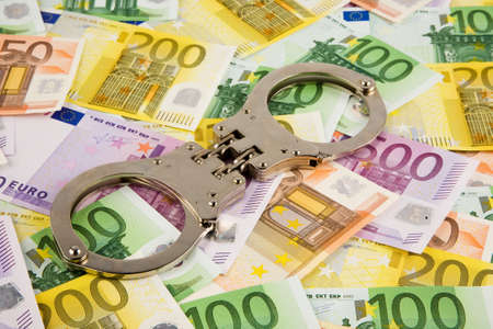 Euro bank notes and handcuffs. Image for economic crimeの写真素材