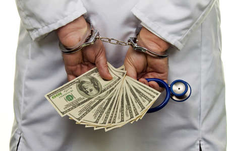 Handcuffs and dollar bills. Photo icon collar crime.の写真素材