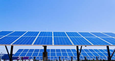 A solar system for solar energy against a blue sky with cloudsの写真素材