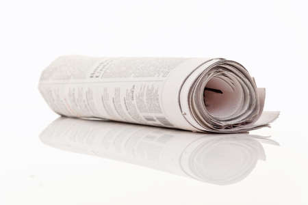 A newspaper lies on a white backgroundの写真素材