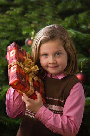Child at Christmas before Christmas with a giftの写真素材