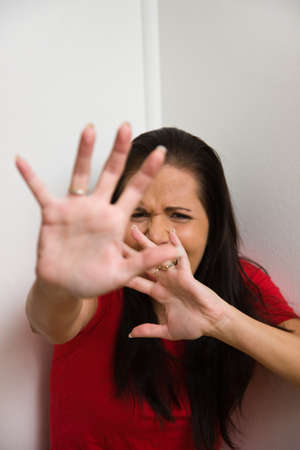 Young woman is afraid of violence in the familyの写真素材