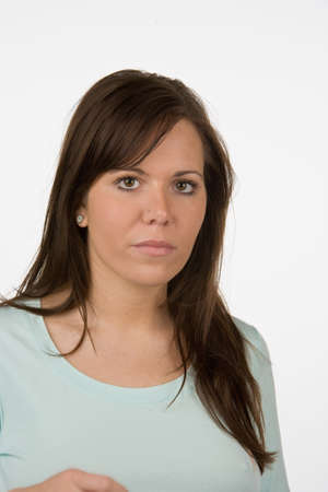 Portrait of a young woman against a white background.の写真素材