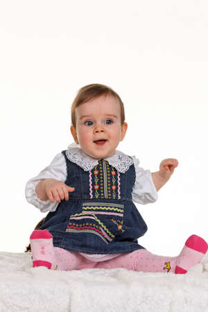 Small happy child - baby sitting on a blanketの写真素材