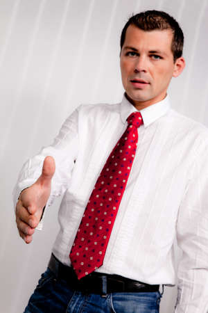 Young business man offers a handshake to greetの写真素材
