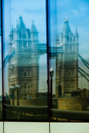 The Tower Bridge in London. Reflection in the window of an office buildingの写真素材