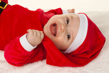 Little baby dressed as Santa Claus. Infant as Santa Clausの写真素材