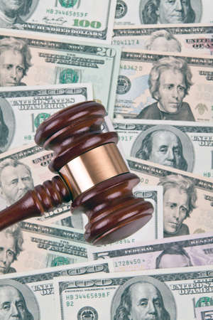 Many dollar bills with a gavel. Legal costs - legal fees.の写真素材