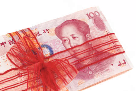 Chinese yuan banknotes in a red ribbonの写真素材