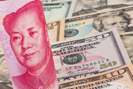 Chinese Yuan banknotes and U.S. dollars Multiple Currenciesの写真素材
