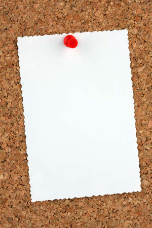 Close-up of a Board of cork with a blank notepadの写真素材