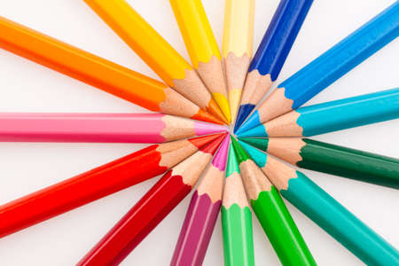 Many different colored pencils on white background
