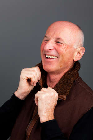 Senior Portraits. Portrait of a friendly elderly man. Recording in the studio.