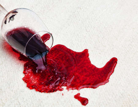 A glass of red wine was spilled on a carpet. Damage insurance.の写真素材
