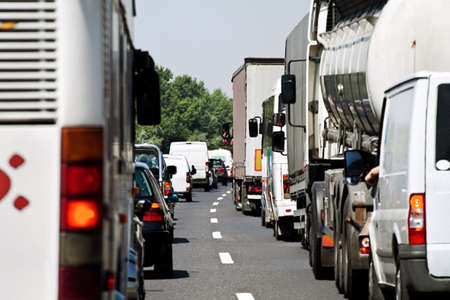 Traffic jam on a highway. Highway traffic jam with cars and trucks Traffic jam on a highway. Highway traffic jam with cars and trucks