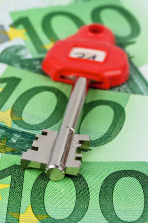Many of euro notes and the key of a safe.の写真素材