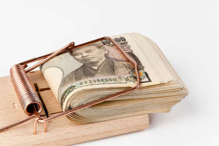 Japanese yen bills in a mousetrap. Japanese moneyの写真素材