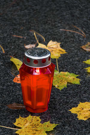 A grave light of All Saints in the fall with leavesの写真素材