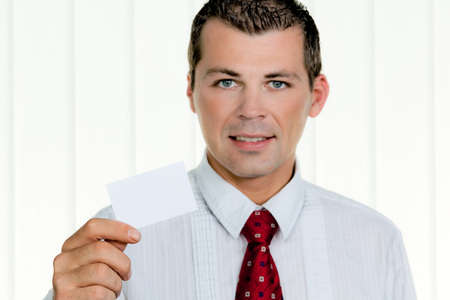 Successful entrepreneurs shows a blank business card in the officeの写真素材