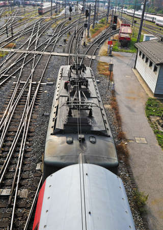 A railroad train with electrical Lokomtovie pulls into a stationの写真素材