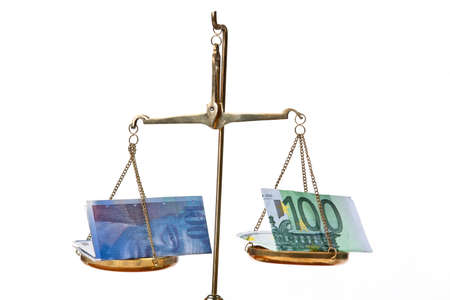 Euro and Swiss franc on a balanceの写真素材