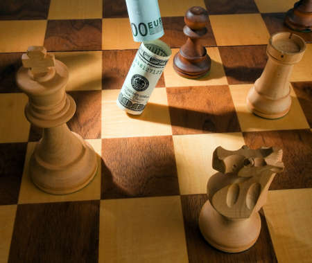 Chess with dollar and euro banknote. Symbol for devaluation of the dollar against the Euro.の写真素材
