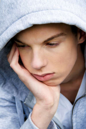 A cool-looking young man in front of graffitiの写真素材