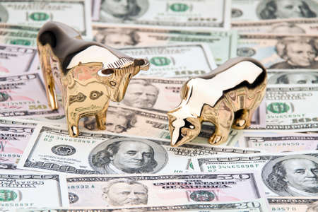 Many dollar bills with bull and bear. Investment in sharesの写真素材