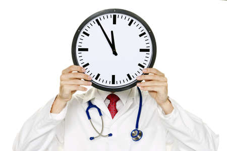 A doctor in trouble with Clock in front of the head. Working in Kranklenhaus.の写真素材