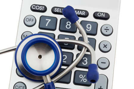 A stethoscope is located on a calculator. Health care costsの写真素材