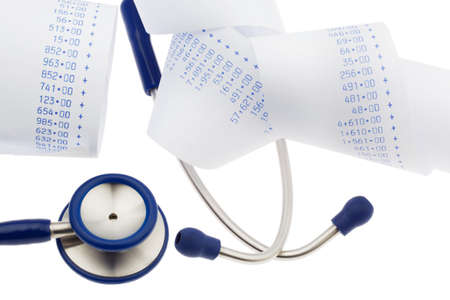 A stethoscope is on a balance sheet. Health care costsの写真素材