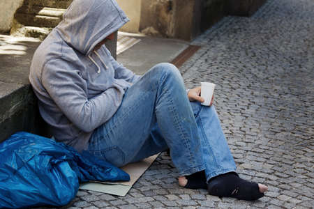 A homeless person looking for new work. Unemployed beggars living on the street.の写真素材